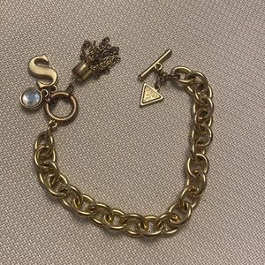 8” Guess charm bracelet with 4 charms attached gold tone